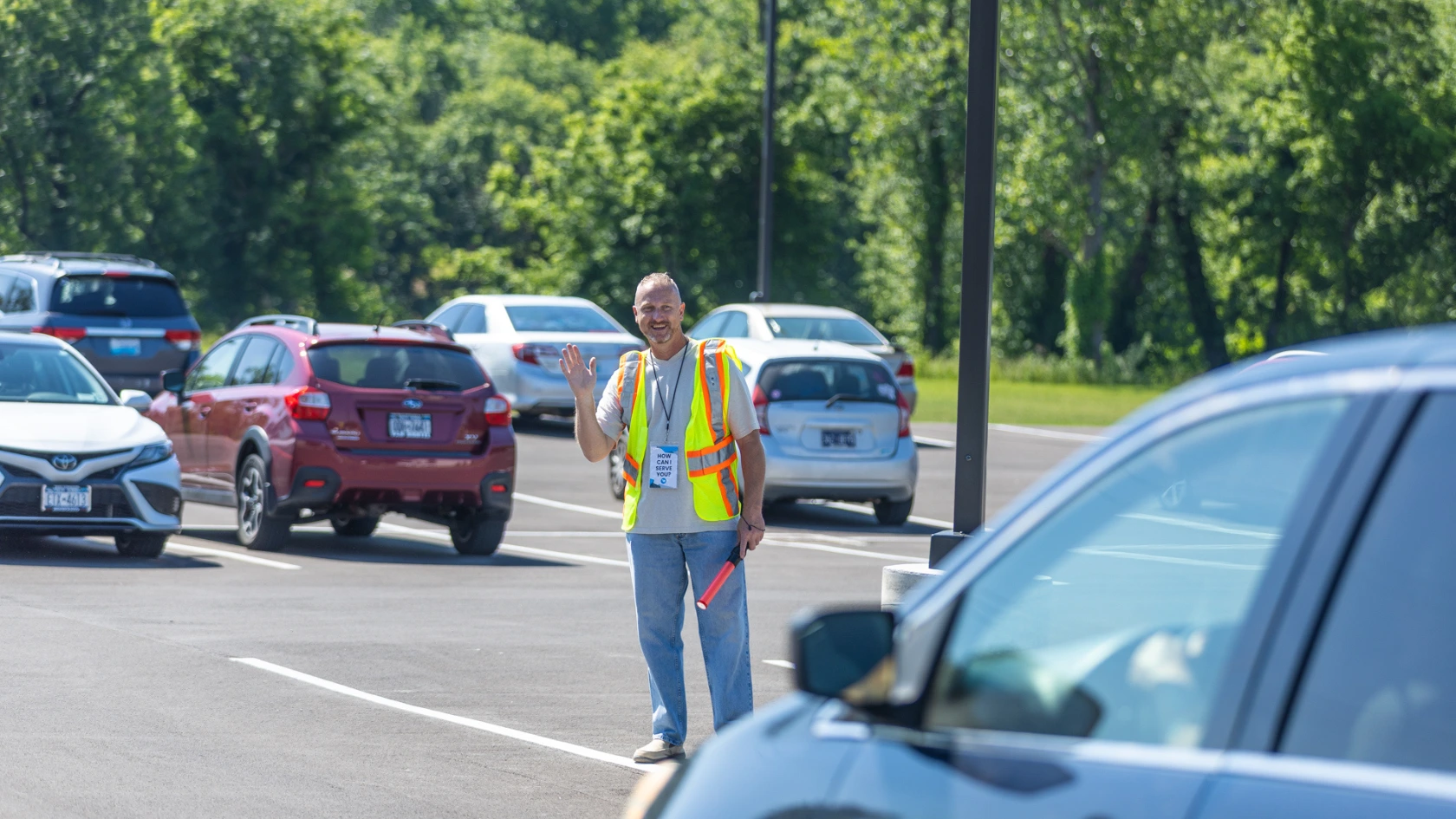 Allen on the parking lot team directing a car