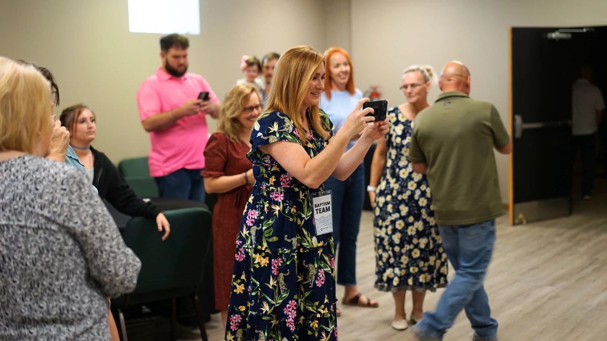 Brittany taking photos of people who have just been baptized