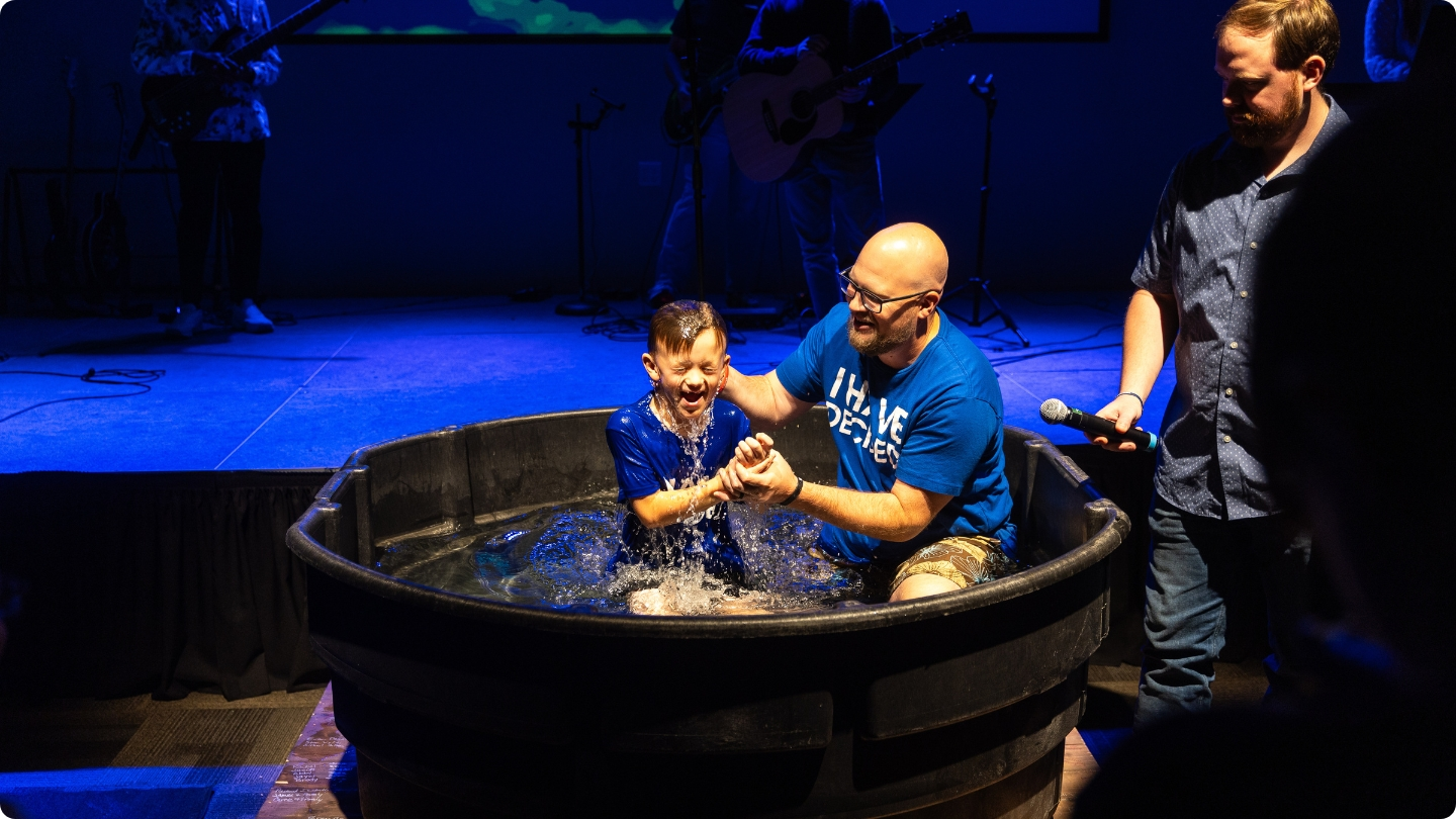 A pastor baptizing a child who was ready for baptism at our Williamsburg Campus.