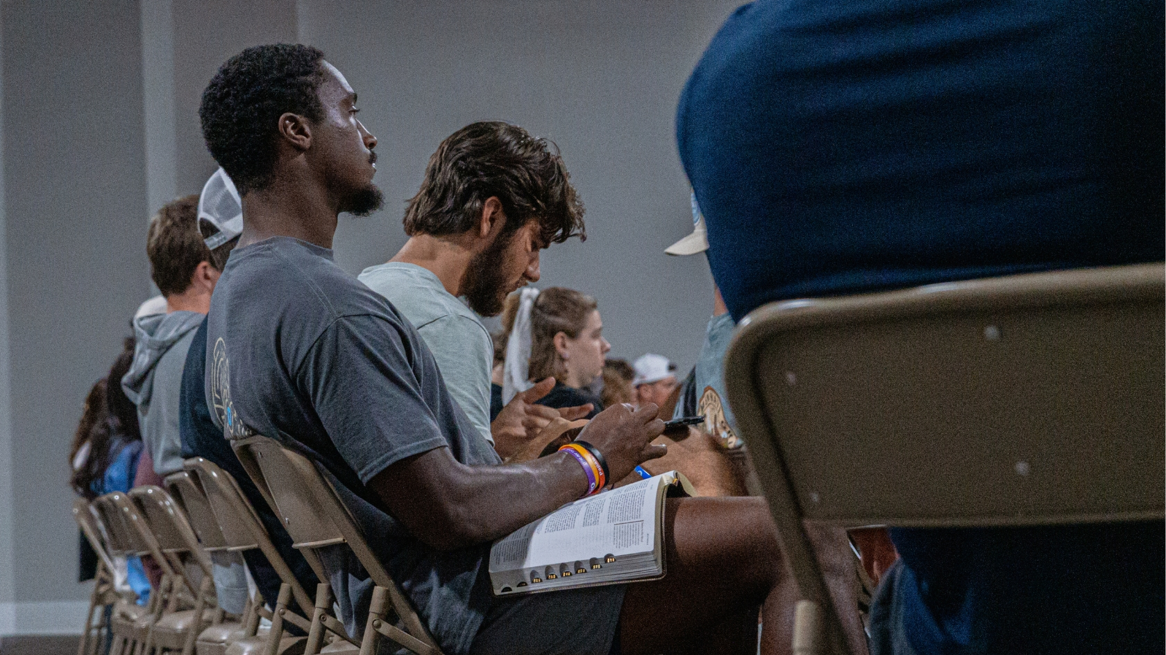 A Young man taking notes during church