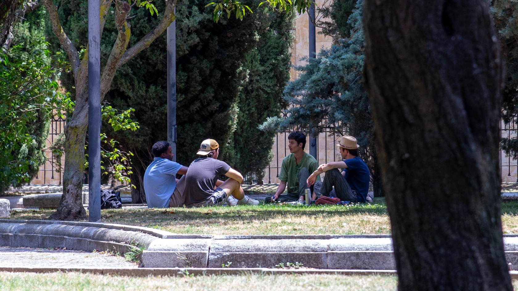 Christian men sharing their testimonies with other young men in a park