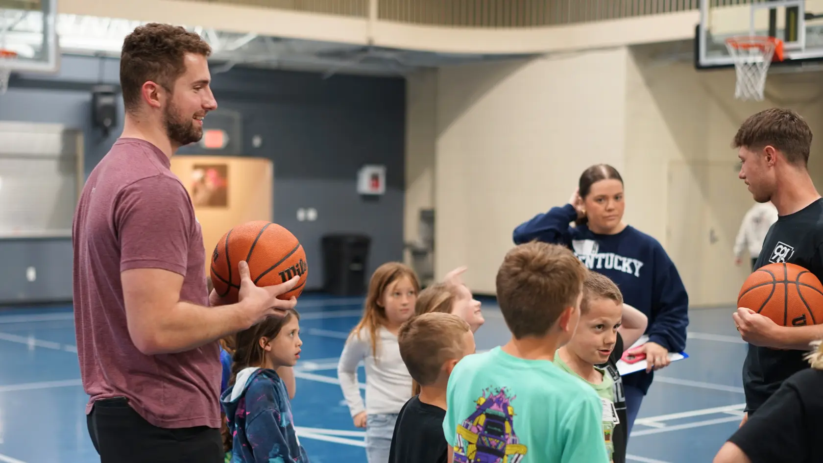 IBCKids ministry leaders on a basketball court with children