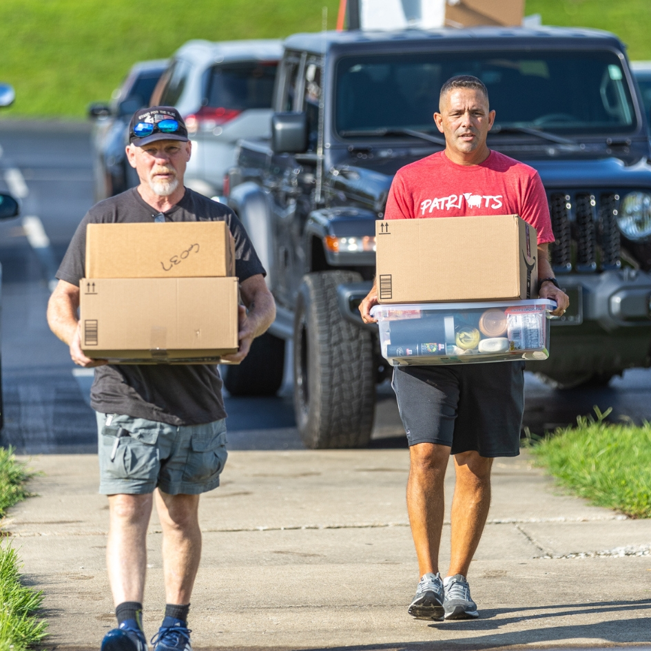 Men helping carry boxes