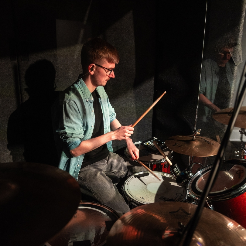 man playing drums for worship team